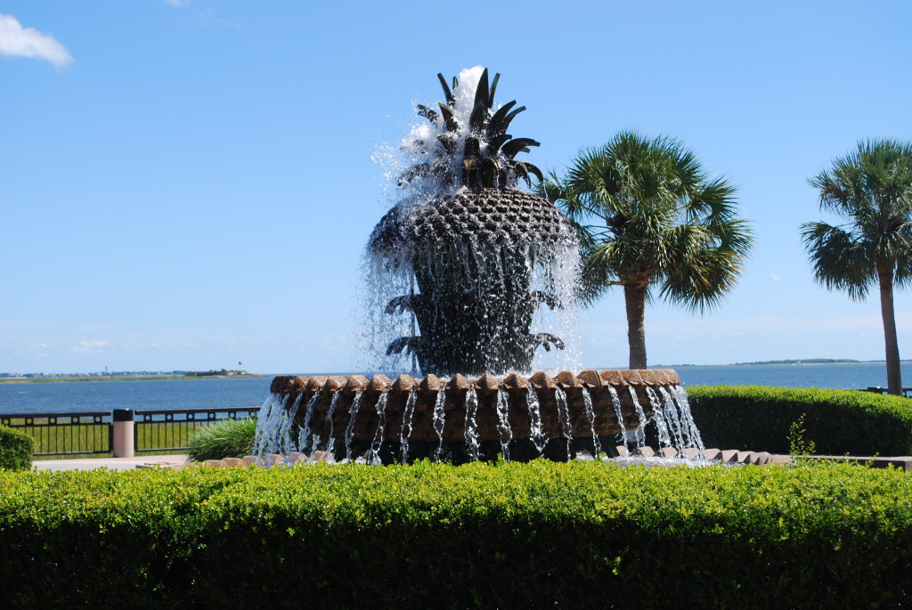A fountain in the waterfront park that looks like a pineapple.