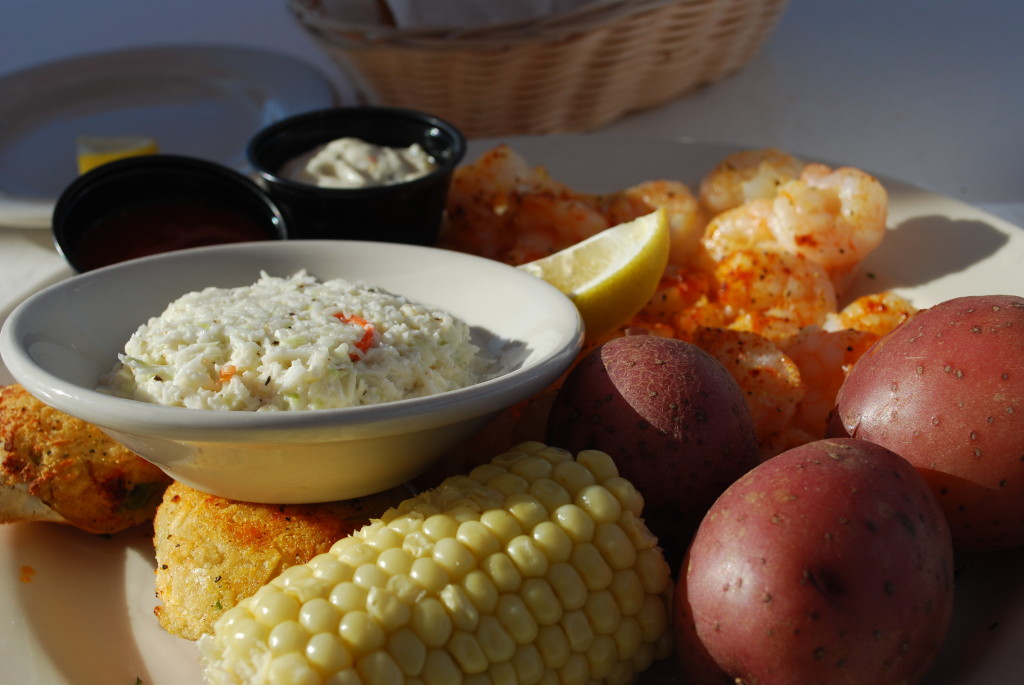 Broiled shrimp and stuffed crab with corn on the cob, potatoes, and coleslaw.